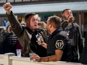 Race goers cheer at the trackside at Wolverhampton