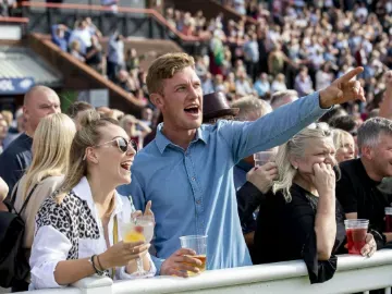 A couple laughing and enjoying the races at Wolverhampton