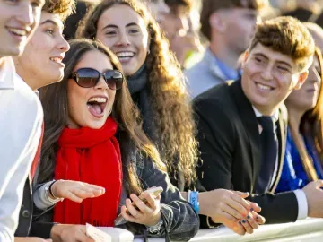 A group of young racegoers watch from the trackside at Wolverhampton Races