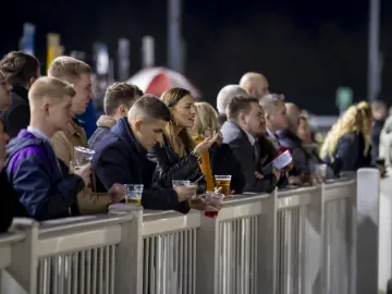 Race goers at Wolverhampton line the trackside ready for a race
