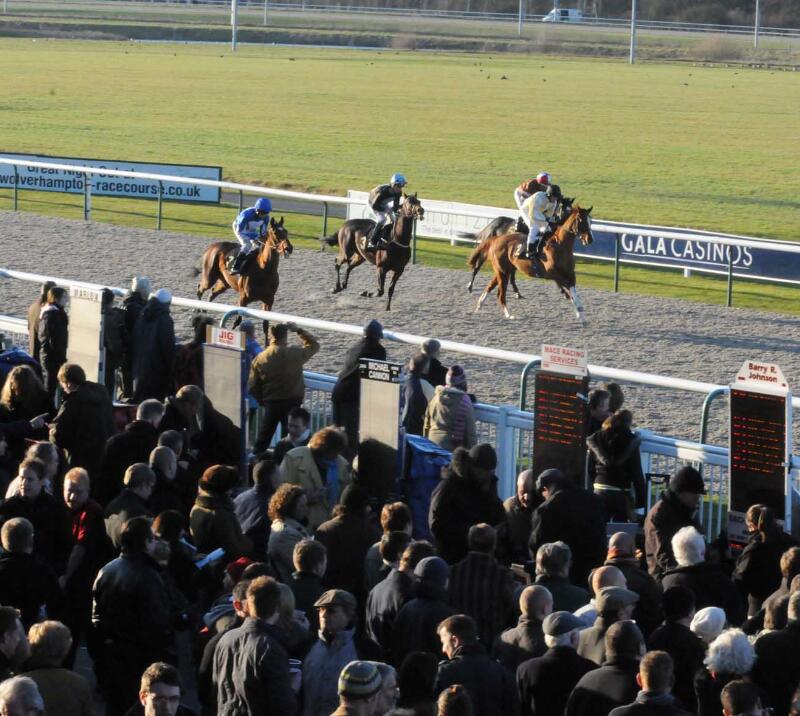 The race unfolds at Wolverhampton in front of the crowds and betting stands