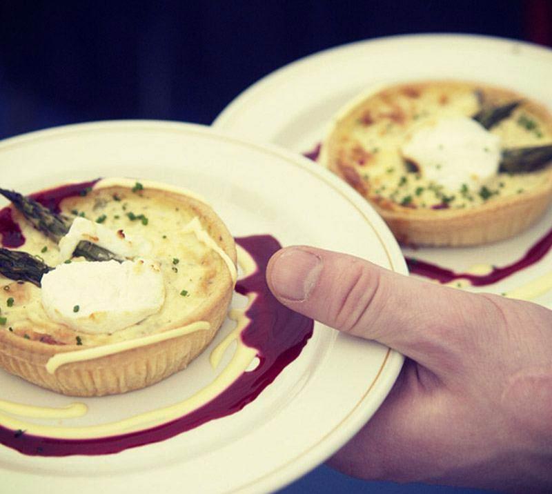 Waiter holding two plates of starters.
