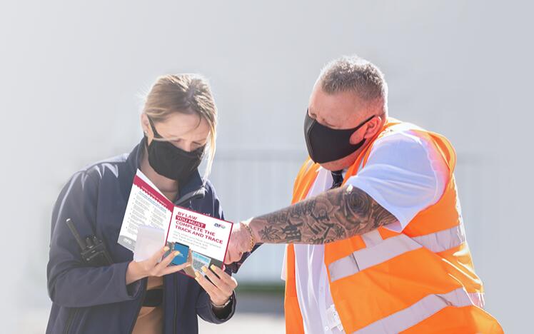 A customer is helped by a member of staff at Wolverhampton Racecourse