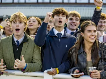 Young racegoers to Wolverhampton Racecourse pull shocked faces at the racing