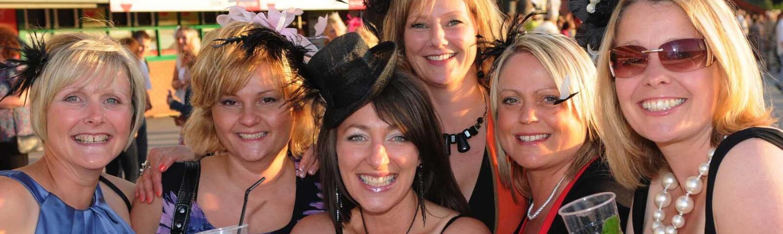 A group of ladies smiling in the sunshine at Wolverhampton Races