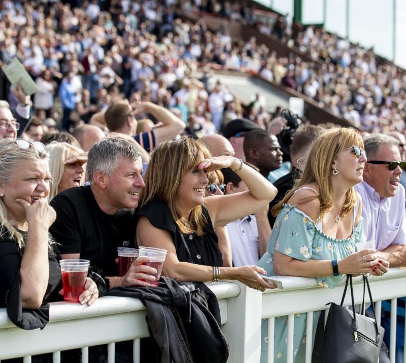 Race goers on the trackside looking out over the track at Wolverhampton Races