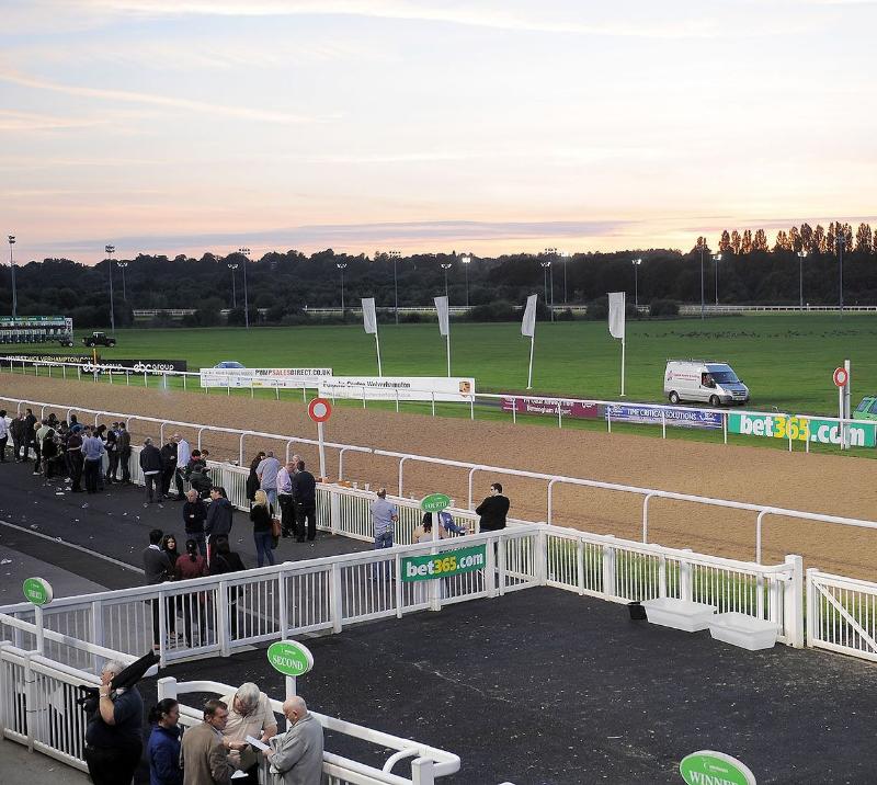 A crowd begin to gather by the finishing post at Wolverhampton Racecourse