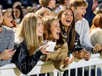 Young girls in the crowd cheering at Wolverhampton Racecourse