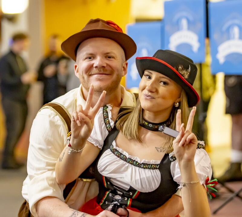 A couple dressed for Oktoberfest enjoy the event at Wolves Races