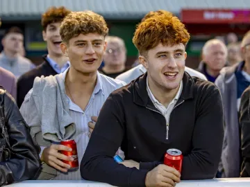 Two young lads watch the racing at Wolverhampton from the trackside