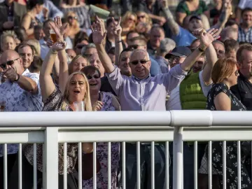 The crowd at Wolverhampton Races poses excitedly for a photo