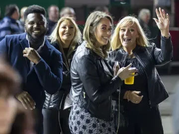 A group of race goers at Wolverhampton pose and smile for the camera