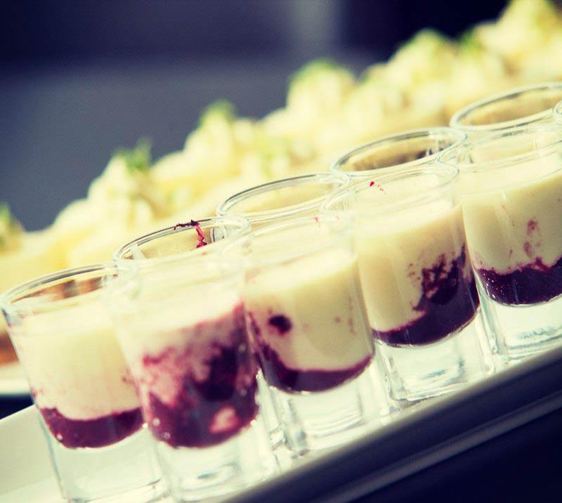 Close up of bunch of glasses with desserts.