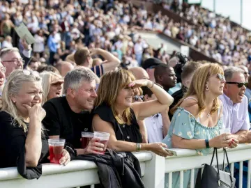 The crowd at Wolverhampton Racecourse look out over the race track
