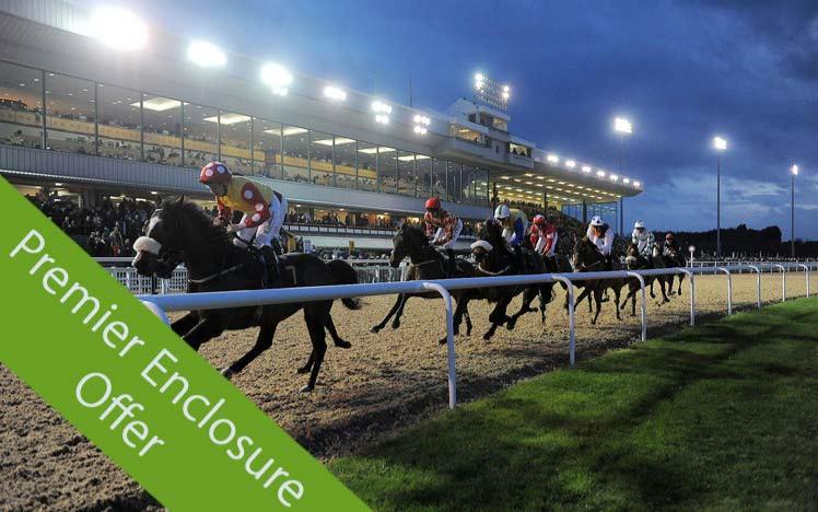 Jockeys racing past grandstand at Wolverhampton Racecourse.