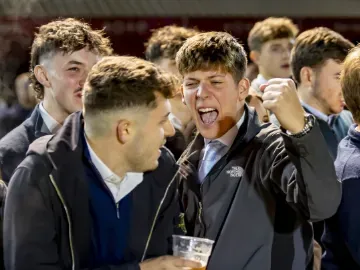 A race goer enthusiastically cheers for a winner at Wolverhampton Racecourse